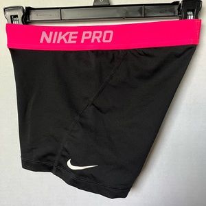 Black Nike Pros, with a pink band.